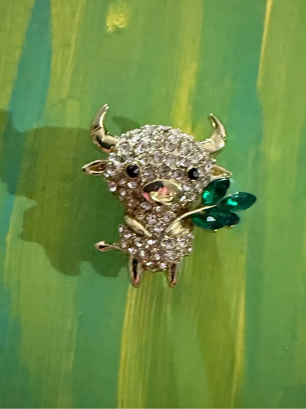Crystal Buffalo Brooch with Green Leaf Accent